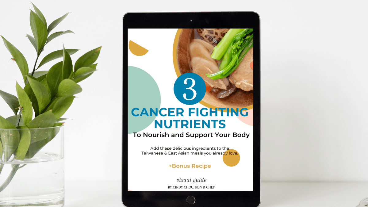 An iPad with the 3 Cancer Fighting Nutrients guide cover open, next to a clear vase filled with green leaves.